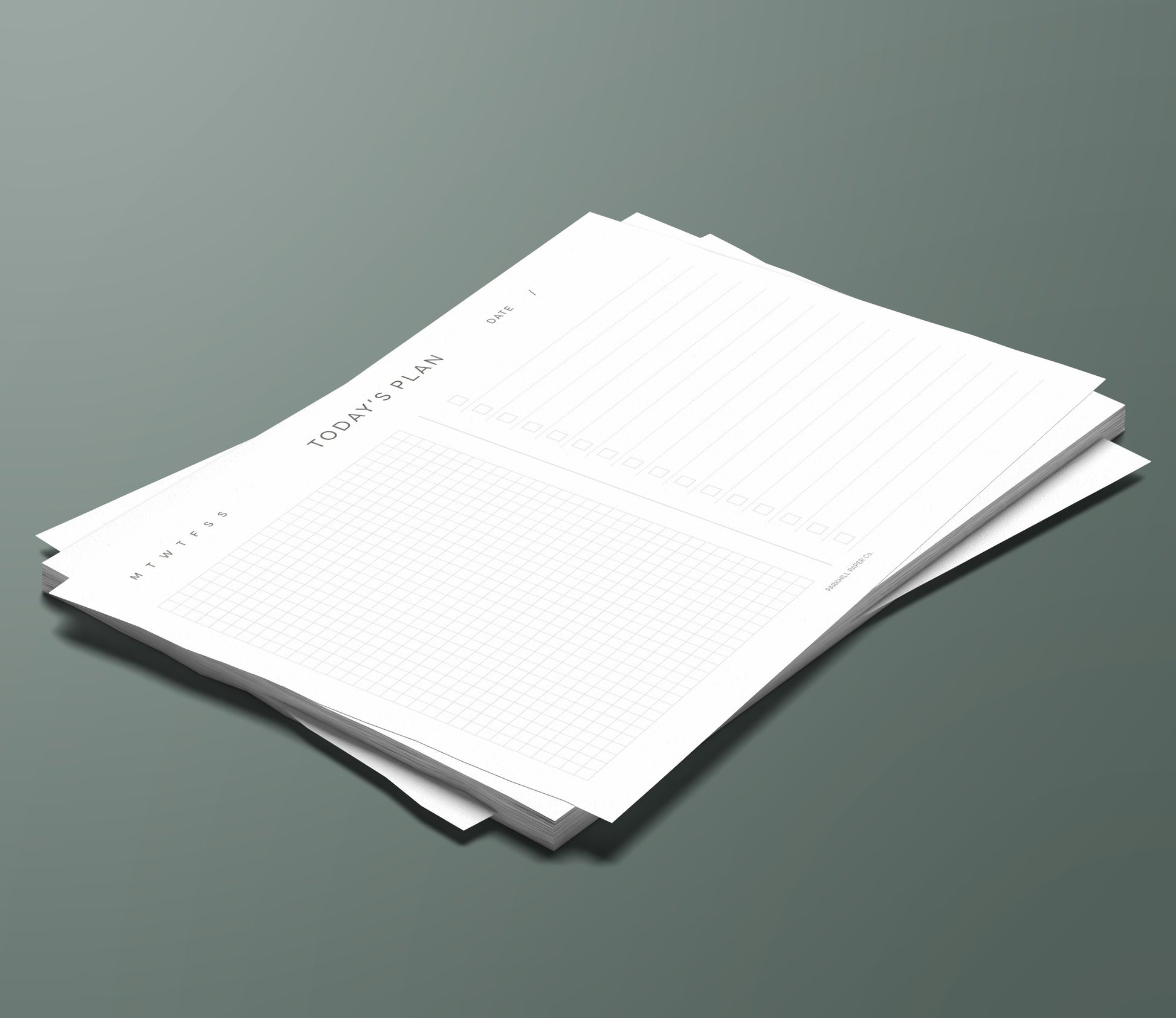 A set of Today's Plan planning pages sitting in a stack on a green background