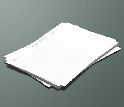 A set of Today's Plan planning pages sitting in a stack on a green background